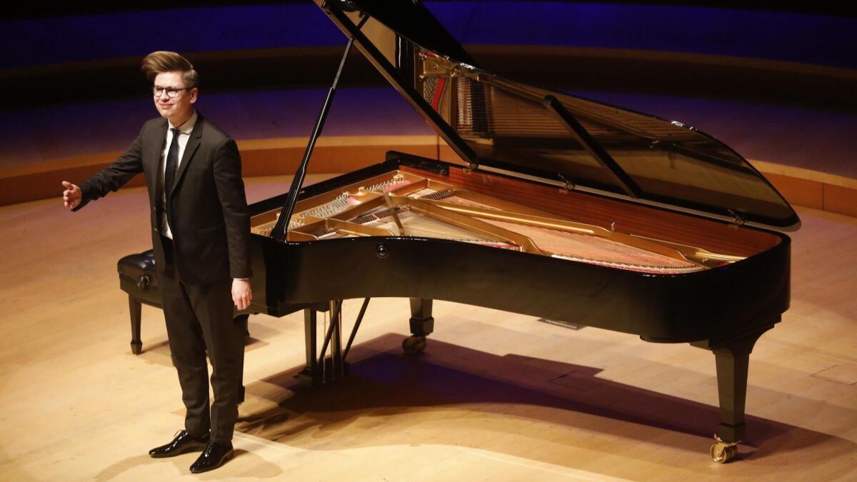 Víkingur Ólafsson takes a bow after his Bach set in his piano recital at Walt Disney Concert Hall on Sunday night.