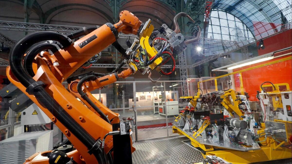 An assembly line robot at the "Extraordinary Factory" exhibition at Paris' Grand Palais in November.