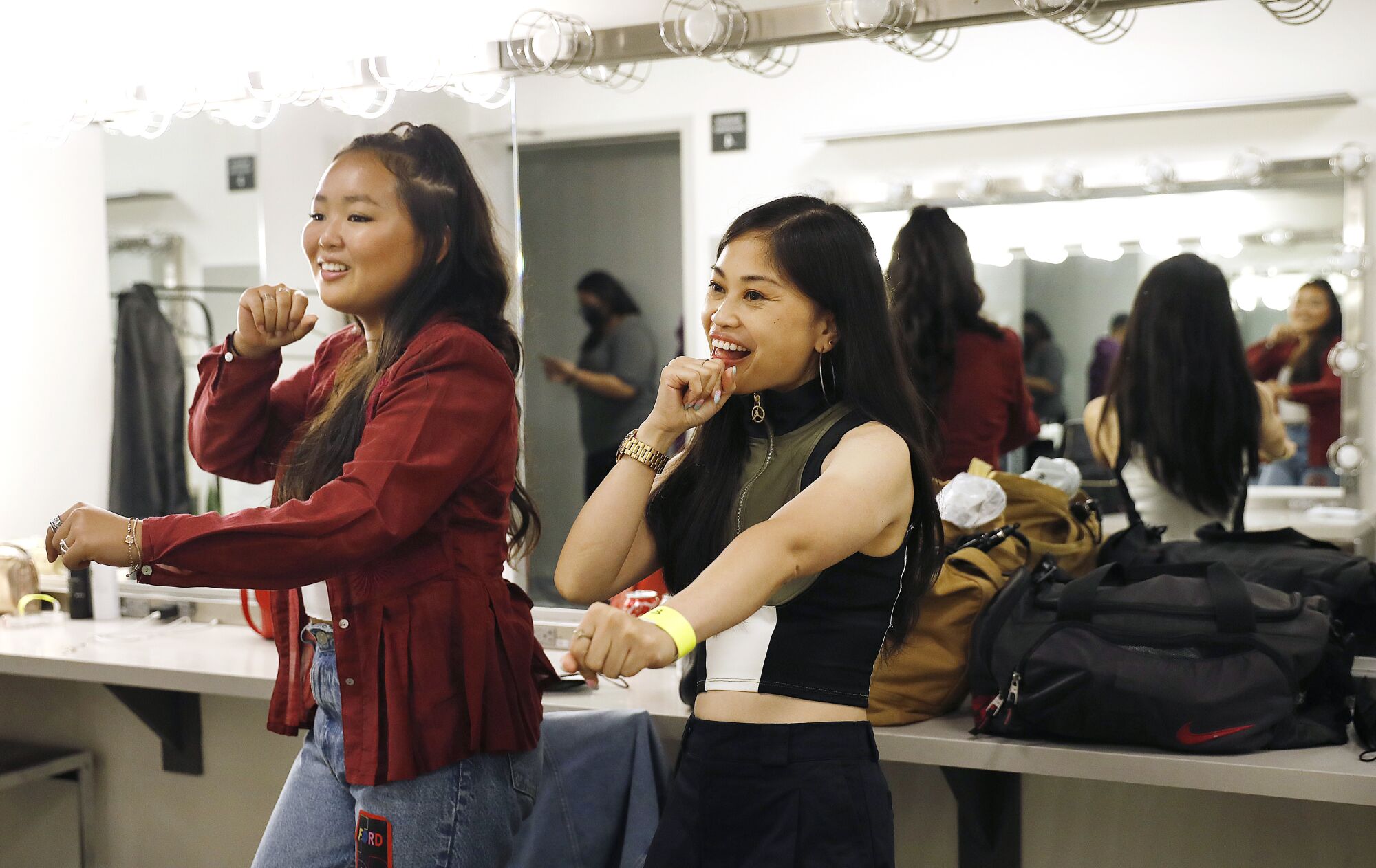 Ella Jay Basco, left, and Ruby Ibarra rehearse in the dressing room.