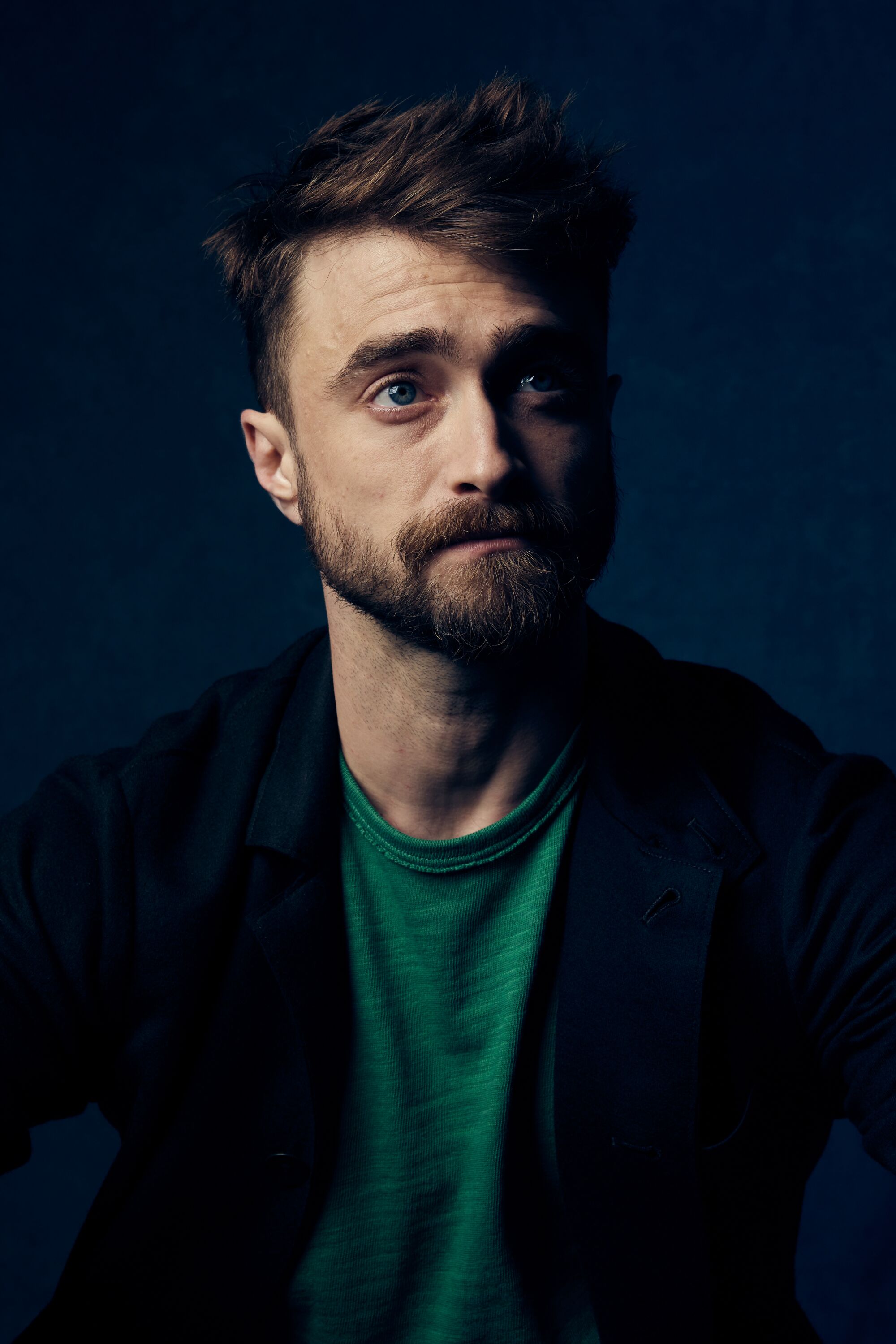 An actor in a green shirt and black jacket