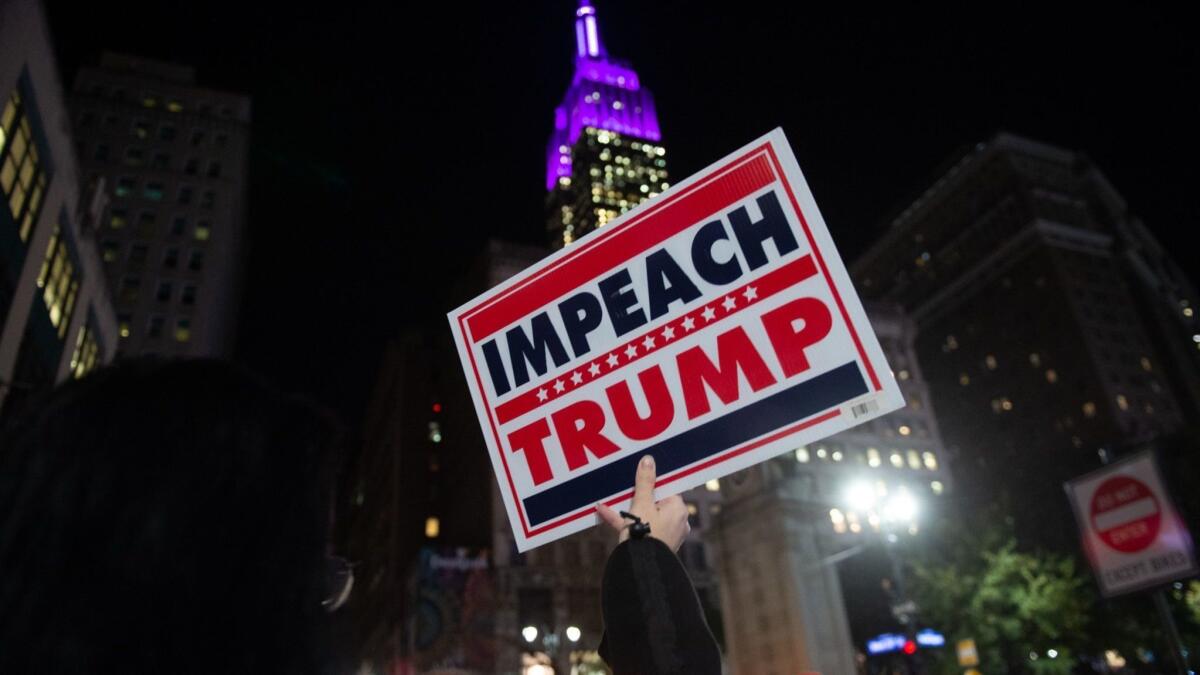 People in New York protest on Nov. 8, 2018, amid reports that President Trump tried to interfere in Robert S. Mueller III's investigation.