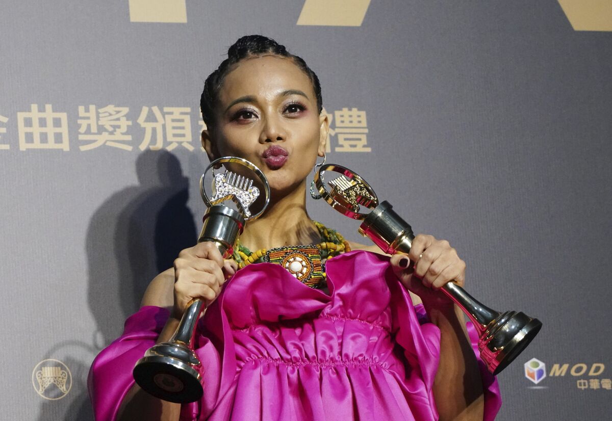 Taiwanese singer Abao holds her awards for Song of the Year and Best Aboriginal Album at the 31th Golden Melody Awards in Taipei, Taiwan, Saturday, Oct. 3, 2020. The awards show, one of the world's biggest Chinese-language pop music annual events was postponed from June to Oct. due to the coronavirus pandemic. (AP Photo/Billy Dai)