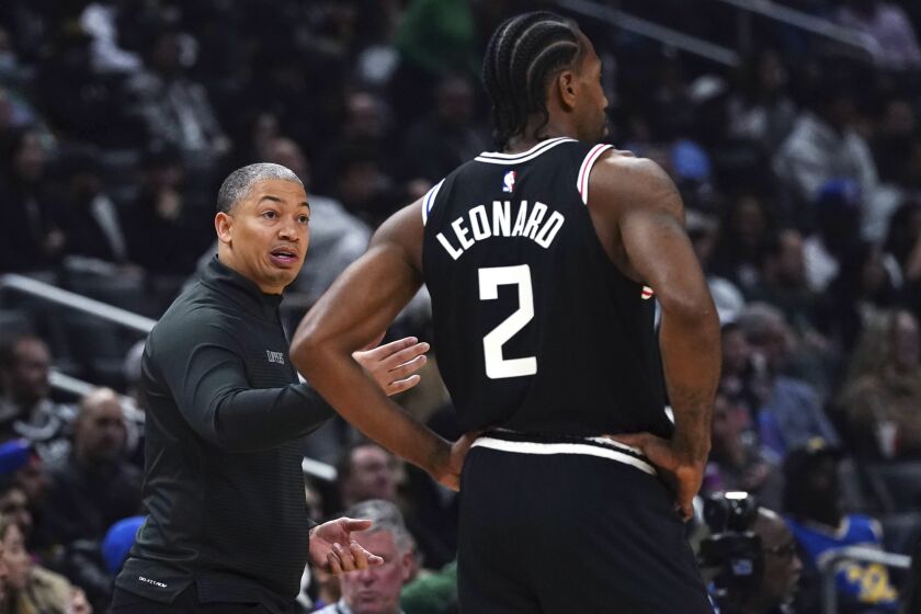 Los Angeles Clippers coach Tyronn Lue talks with forward Kawhi Leonard (2) during the second half of the team's NBA basketball game against the San Antonio Spurs Saturday, Nov. 19, 2022, in Los Angeles. (AP Photo/Allison Dinner)