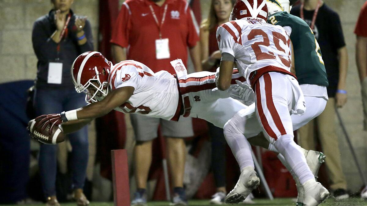 Mater Dei receiver Osiris St. Brown dives into the end zone for a touchdown against Edison late in the second quarter Friday night.