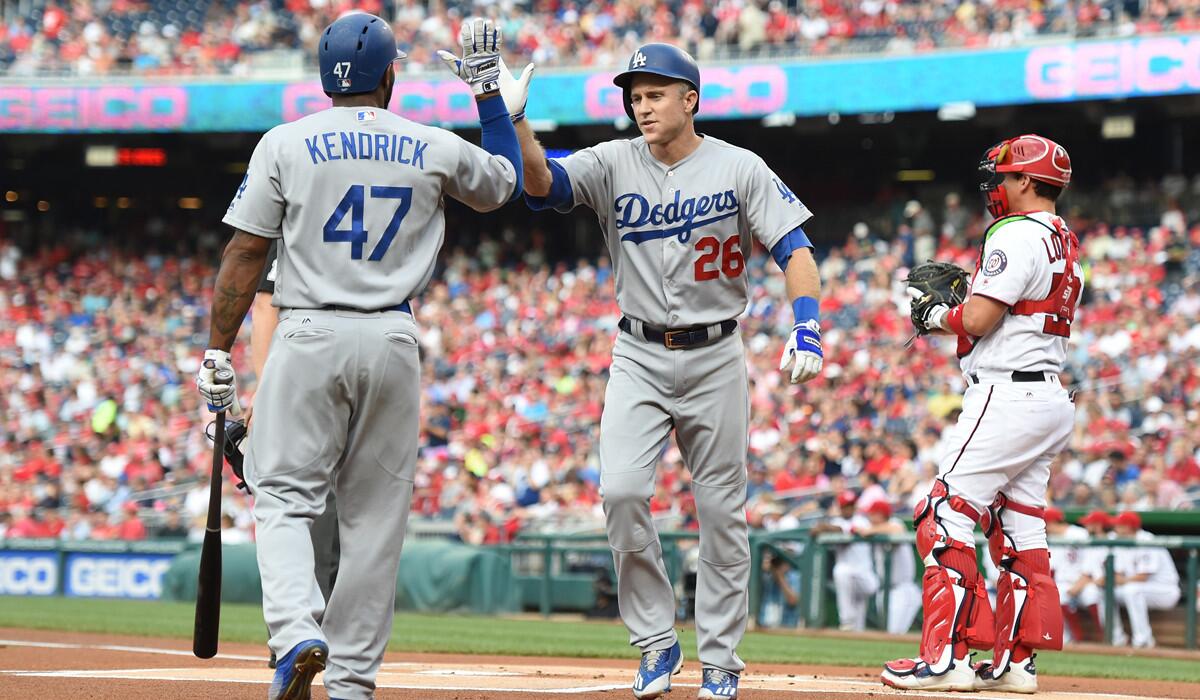 The Dodgers' Chase Utley, right, celebrates a solo home run with Howie Kendrick in the first inning against the Washington Nationals.