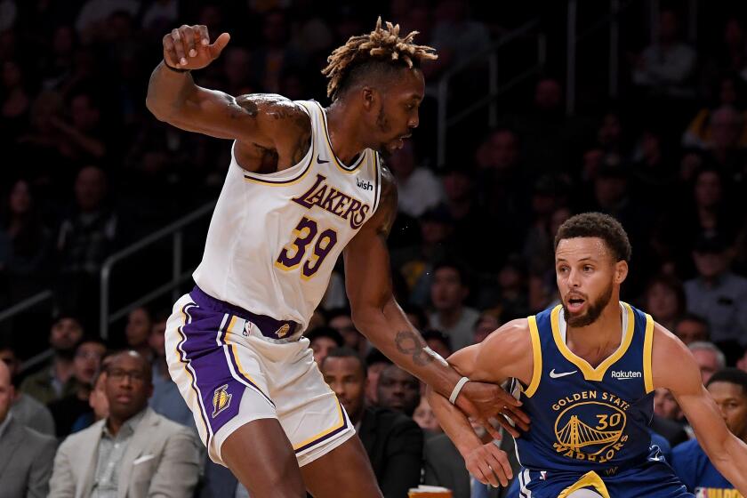 LOS ANGELES, CALIFORNIA - OCTOBER 14: Stephen Curry #30 of the Golden State Warriors dribbles in front of Dwight Howard #39 of the Los Angeles Lakers during the first half at Staples Center on October 14, 2019 in Los Angeles, California. (Photo by Harry How/Getty Images)