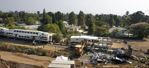 Rescue crews and salvage workers pick through the Metrolink train wreckage near the Santa Susana Pass.