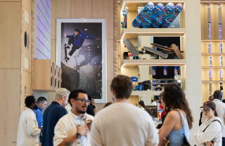 Shoppers milling about Meta Lab; in background, a skateboarding poster