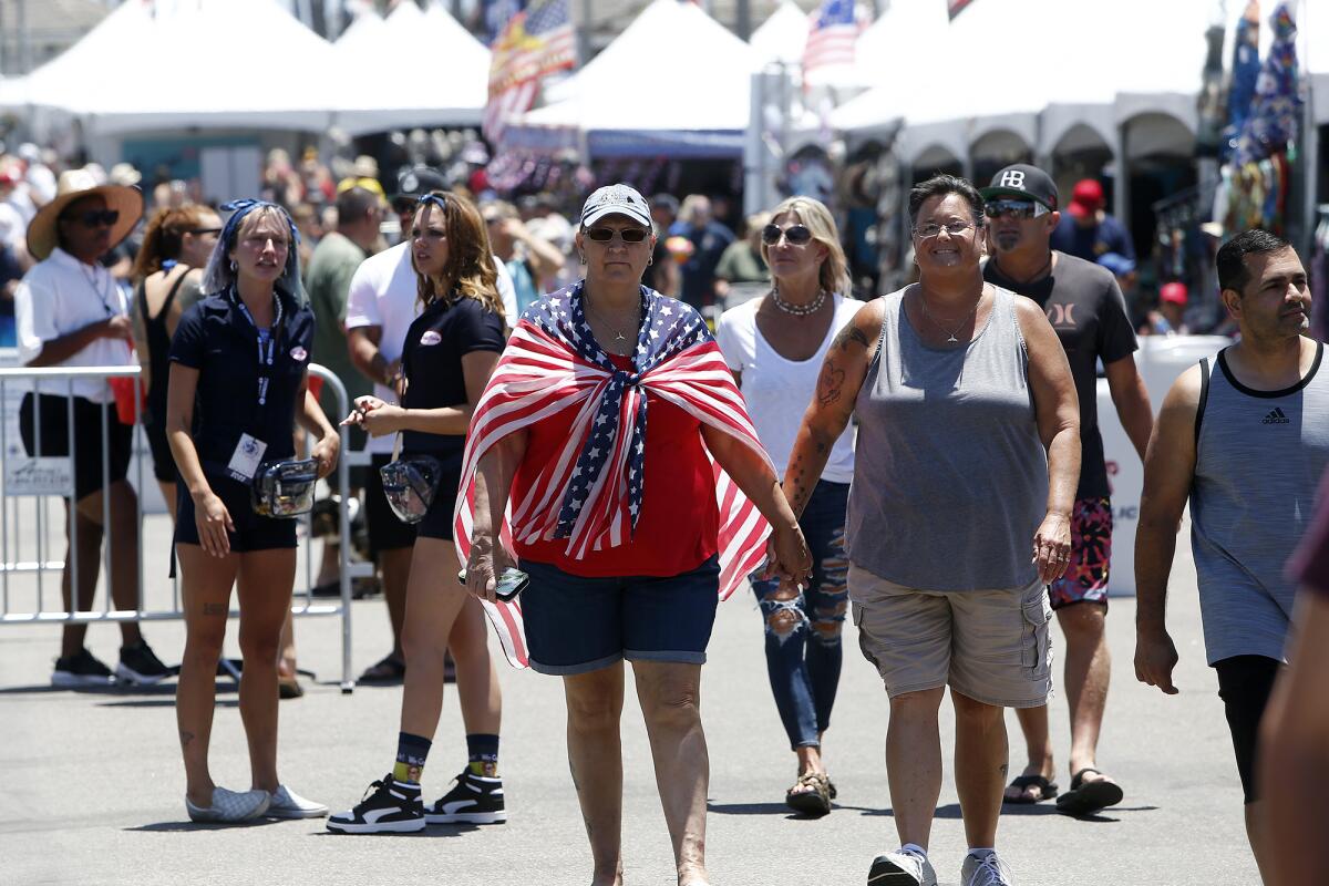 Dozens of festival-goers walk through the vendor area during Pier Plaza Festival on Saturday.