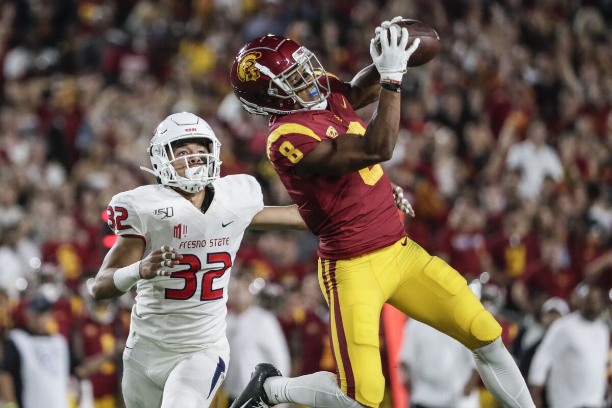 USC receiver Amon-Ra St. Brown hauls in a long pass against Fresno State at the Coliseum on Aug. 31.