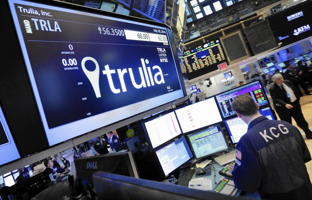 A specialist works at the post that handles Trulia on the floor of the New York Stock Exchange. Trulia's stock jumped after Zillow said it planned to buy the company for $3.5 billion.