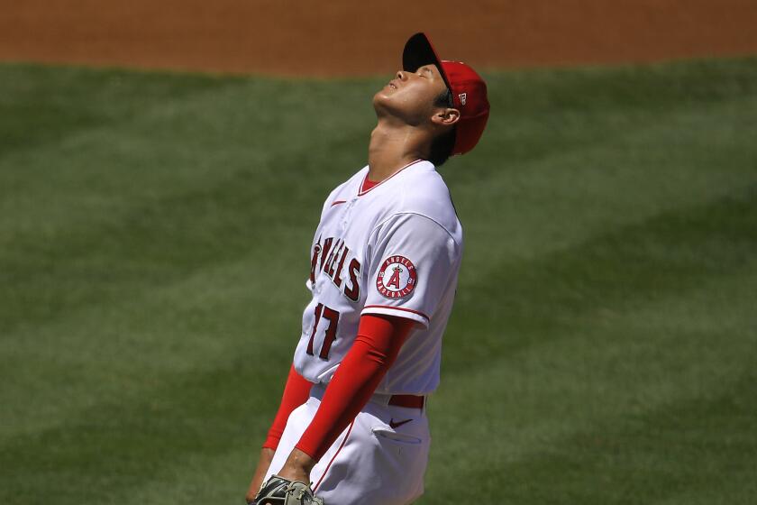 Los Angeles Angels pitcher Shohei Ohtani, of Japan, reacts as he walks in a run.