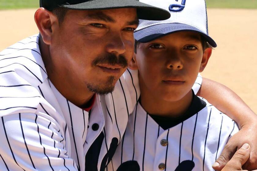 Father and son on baseball field