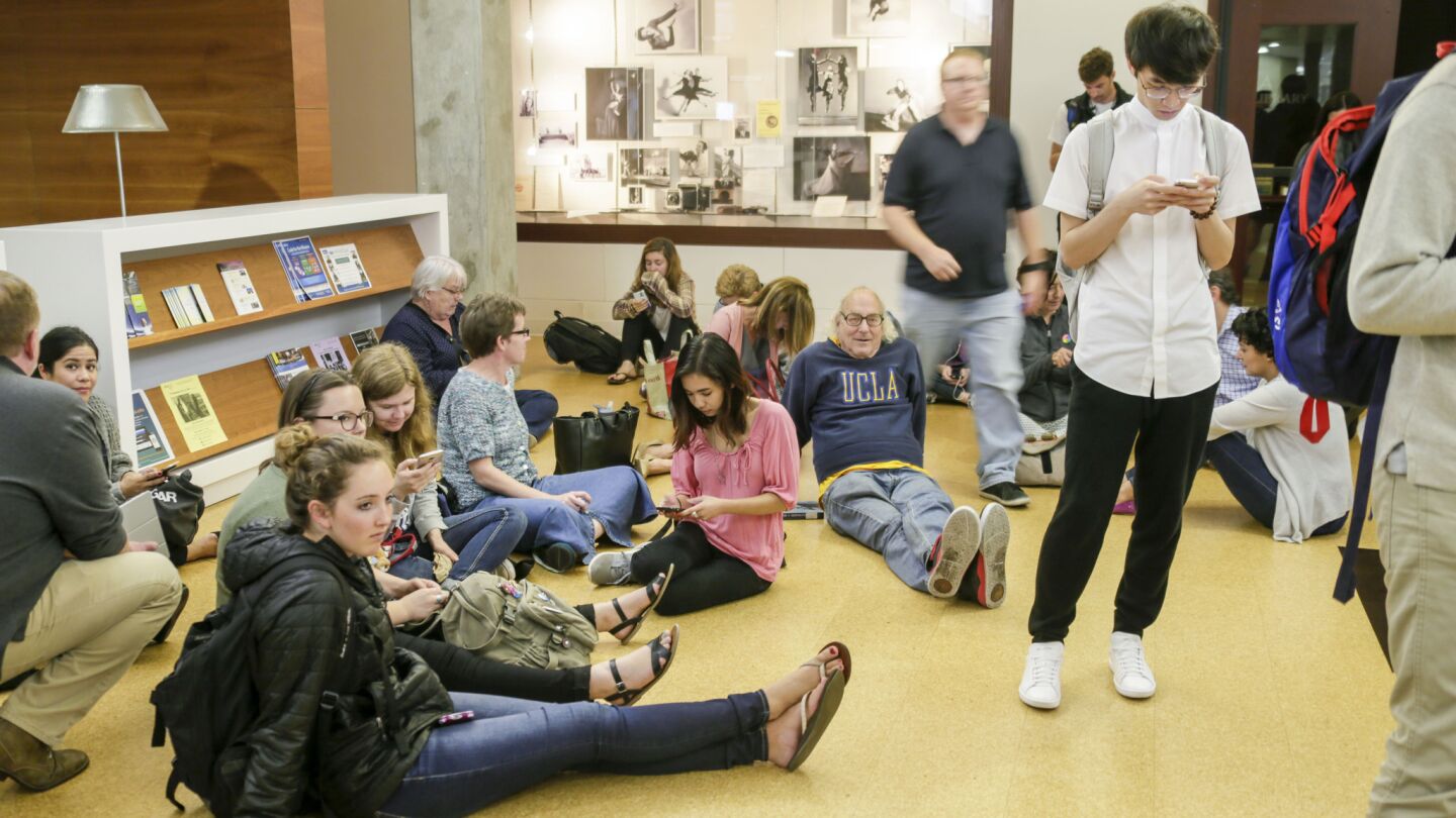 People gather in a campus building after a shooting at UCLA.