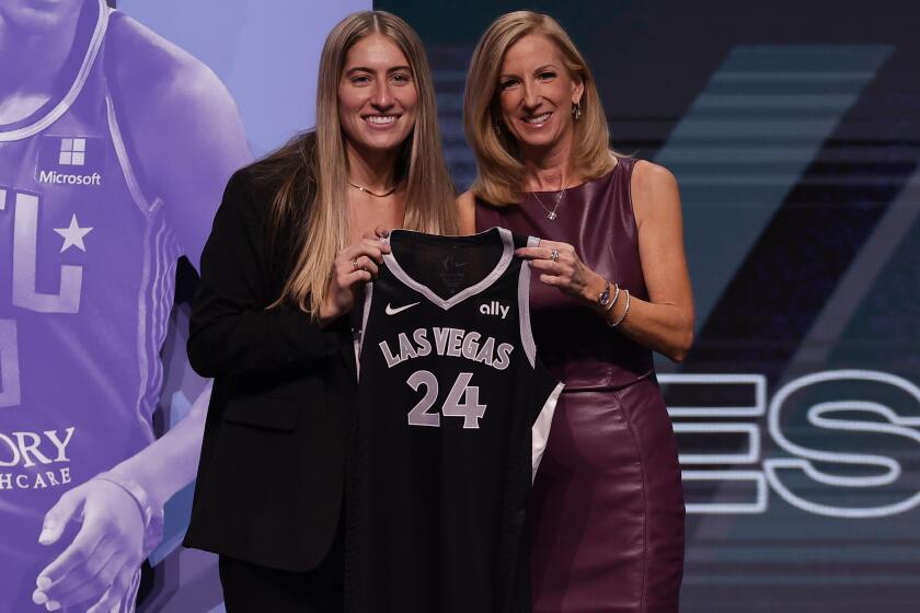 Iowa's Kate Martin, left, poses for a photo with WNBA commissioner Cathy Engelbert, right, after being selected 18th overall by the Las Vegas Aces during the second round of the WNBA basketball draft on Monday, April 15, 2024, in New York. (AP Photo/Adam Hunger)