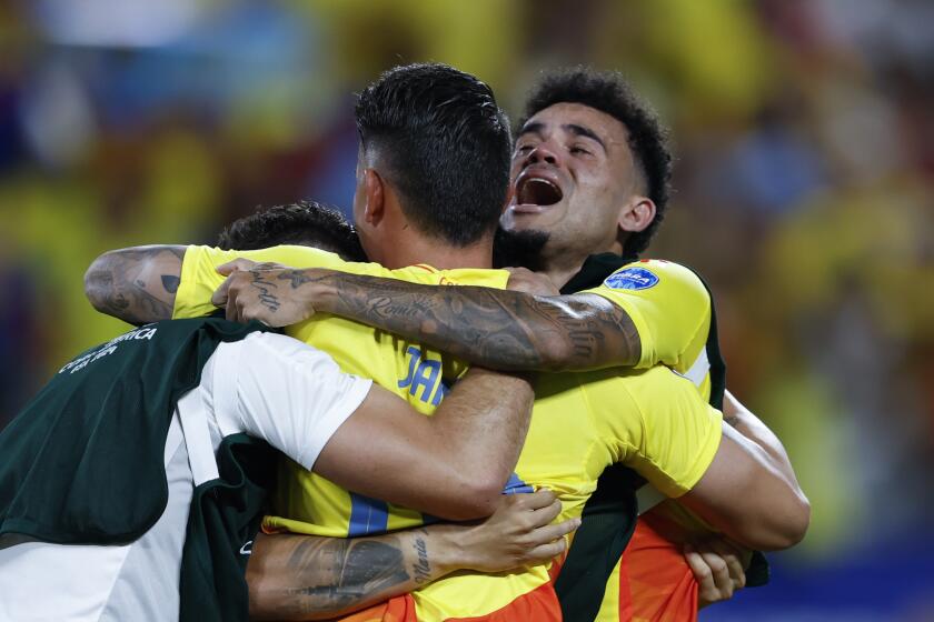 Colombia's Luis Diaz, right, and teammate James Rodriguez, center, celebrate their team's 1-0 victory over Uruguay at the end of a Copa America semifinal soccer match in Charlotte, N.C., Wednesday, July 10, 2024. (AP Photo/Nell Redmond)