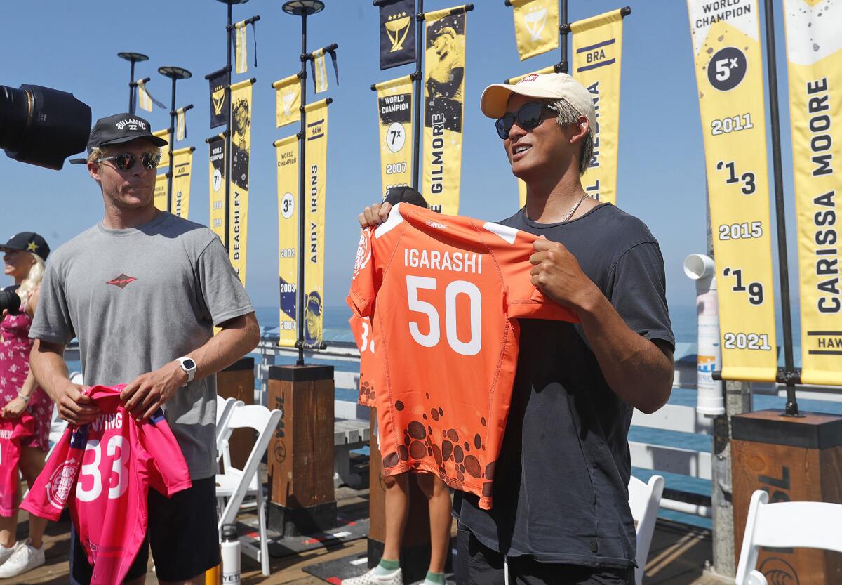Kanoa Igarashi from Huntington Beach holds up his official jersey for the audience during Tuesday's press conference.