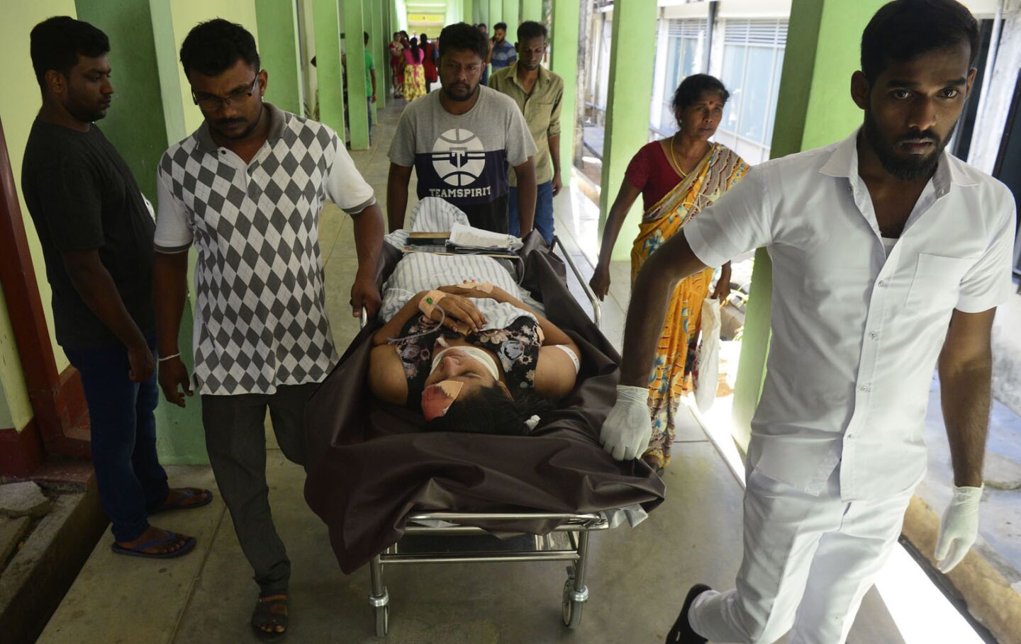 An injured Sri Lankan woman is moved on a hospital stretcher after an explosion at a Batticaloa church.