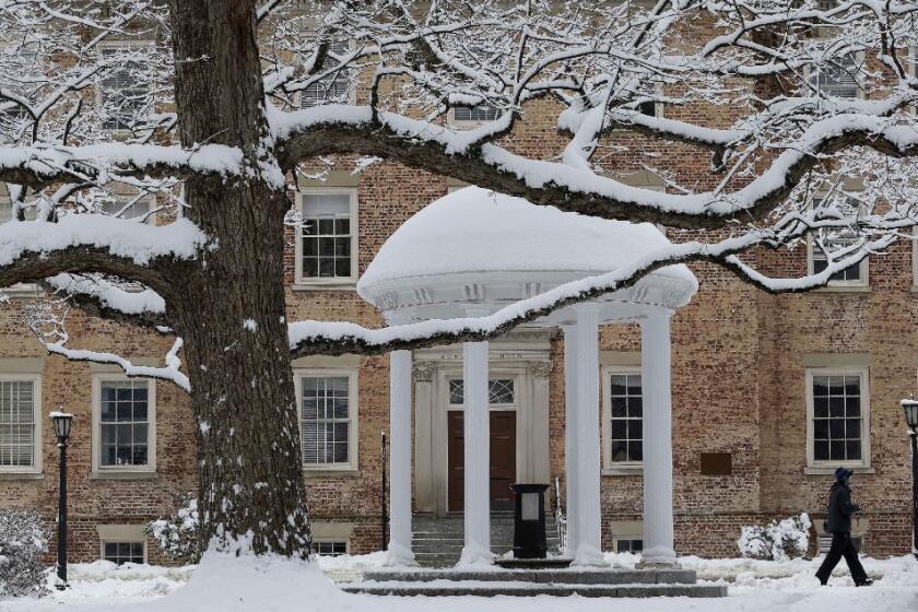 A pedestrian walks past the Old Well on campus at the University of North Carolina in Chapel Hill, N.C., on Feb. 26.