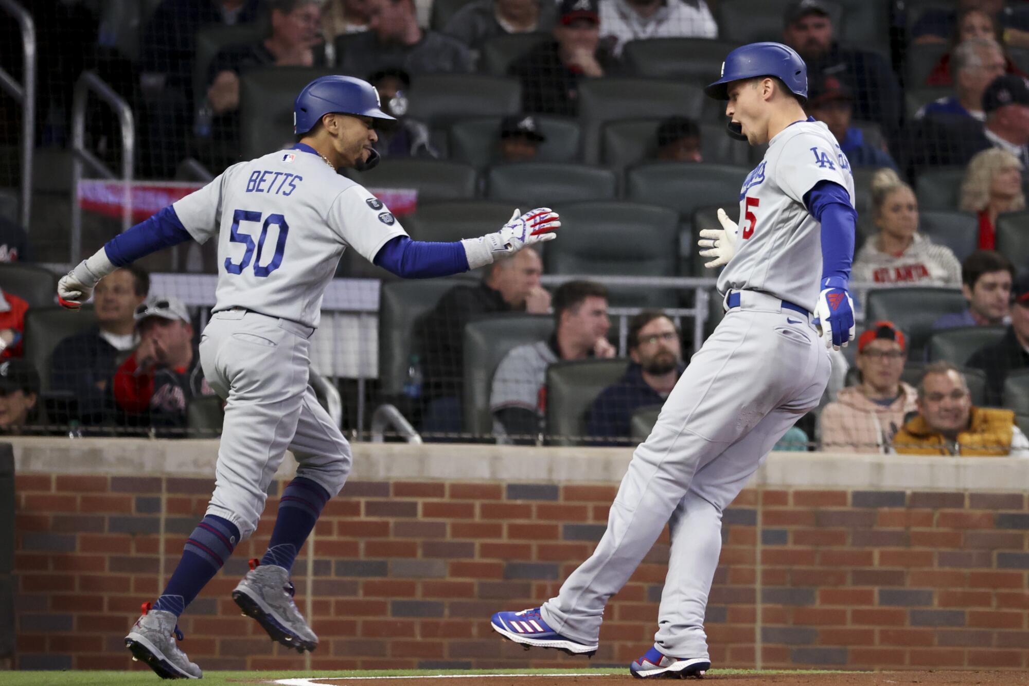 Los Angeles Dodgers' Corey Seager, right, celebrates after a two-run home run with Mookie Betts