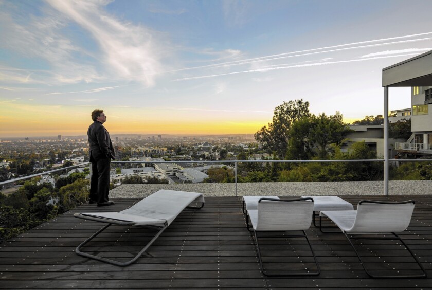 Gerald Casale, a member of the band Devo, watches the sunset from the top patio of the Richard Neutra house.