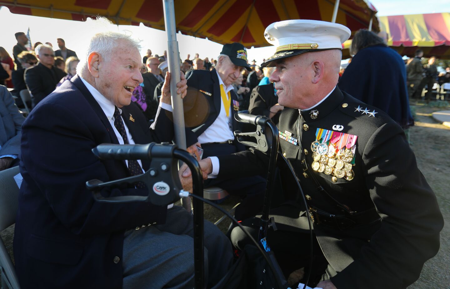 World War II Marine Corps veteran of the Battle of Iwo Jima, Carlo Romano, 95, left, of Fallbrook, talks with Lt. General Joseph Osterman, right, commanding general of the I Marine Expeditionary Force, before the commemoration ceremony for the 75th anniversary of the battle began at Camp Pendleton, February 15. This is the last time the Iwo Jima Commemorative Committee is planning to hold a formal West Coast gathering of veterans of the battle.