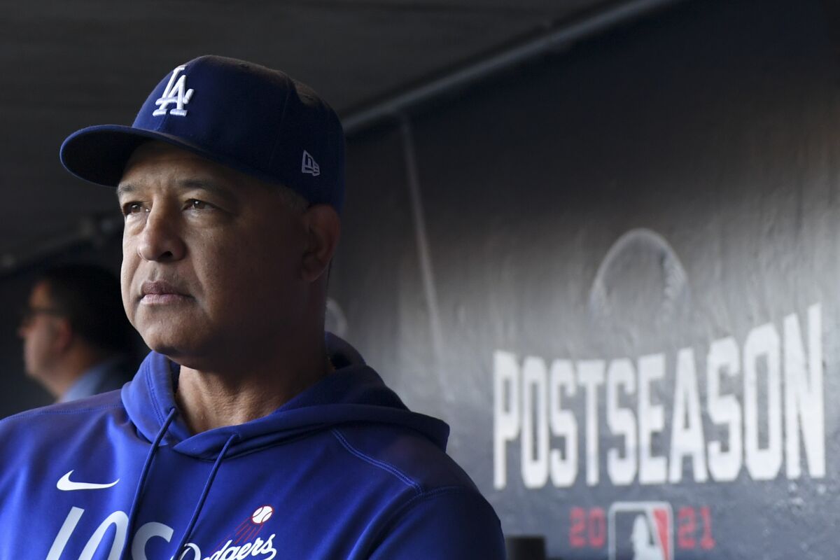 Dodgers manager Dave Roberts looks out from the dugout before Game 5 against the Giants on Thursday.