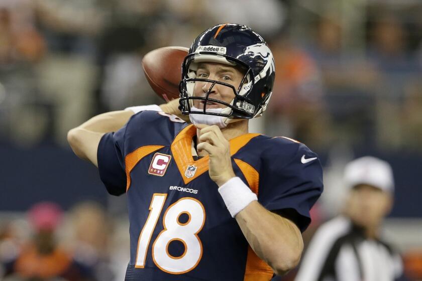 Denver Broncos quarterback Peyton Manning passes with under two minutes to go in the fourth quarter of an NFL football game against the Dallas Cowboys on Sunday.