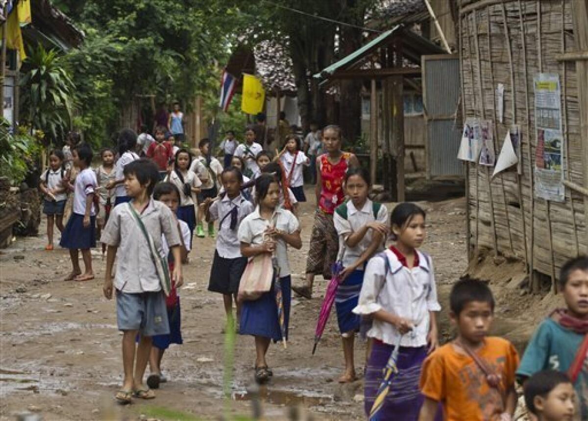 In this photo taken Thursday, July 1, 2010, ethnic Karen children leave school at the Mae Rama Luang Refugee Camp in western Thailand, along the border with Myanmar. The Karen, an ethnic minority people of about 4 million within Myanmar's 43 million, are being pushed by the military from their homes in western Myanmar to the border with Thailand almost daily. Human rights groups and aid workers call it "the hidden Darfur." (AP Photo/David Longstreath)