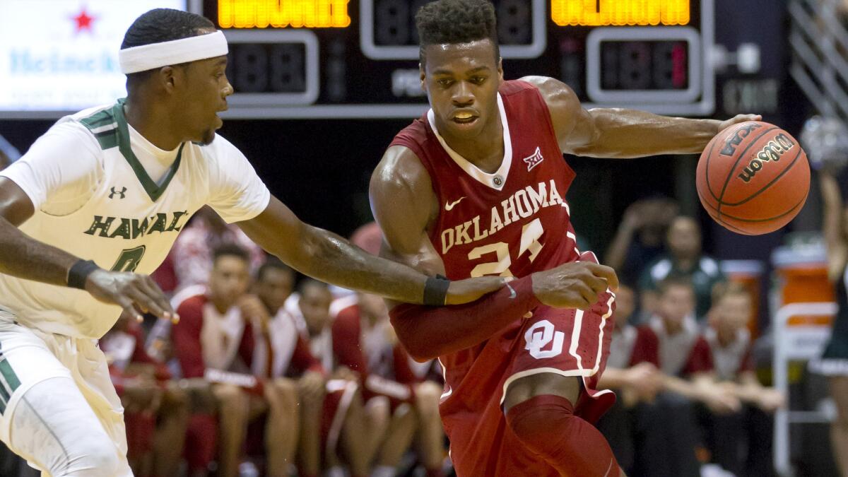 Oklahoma guard Buddy Hield (24) attempts to drive past Hawaii guard Isaac Fleming in the first half Wednesday.