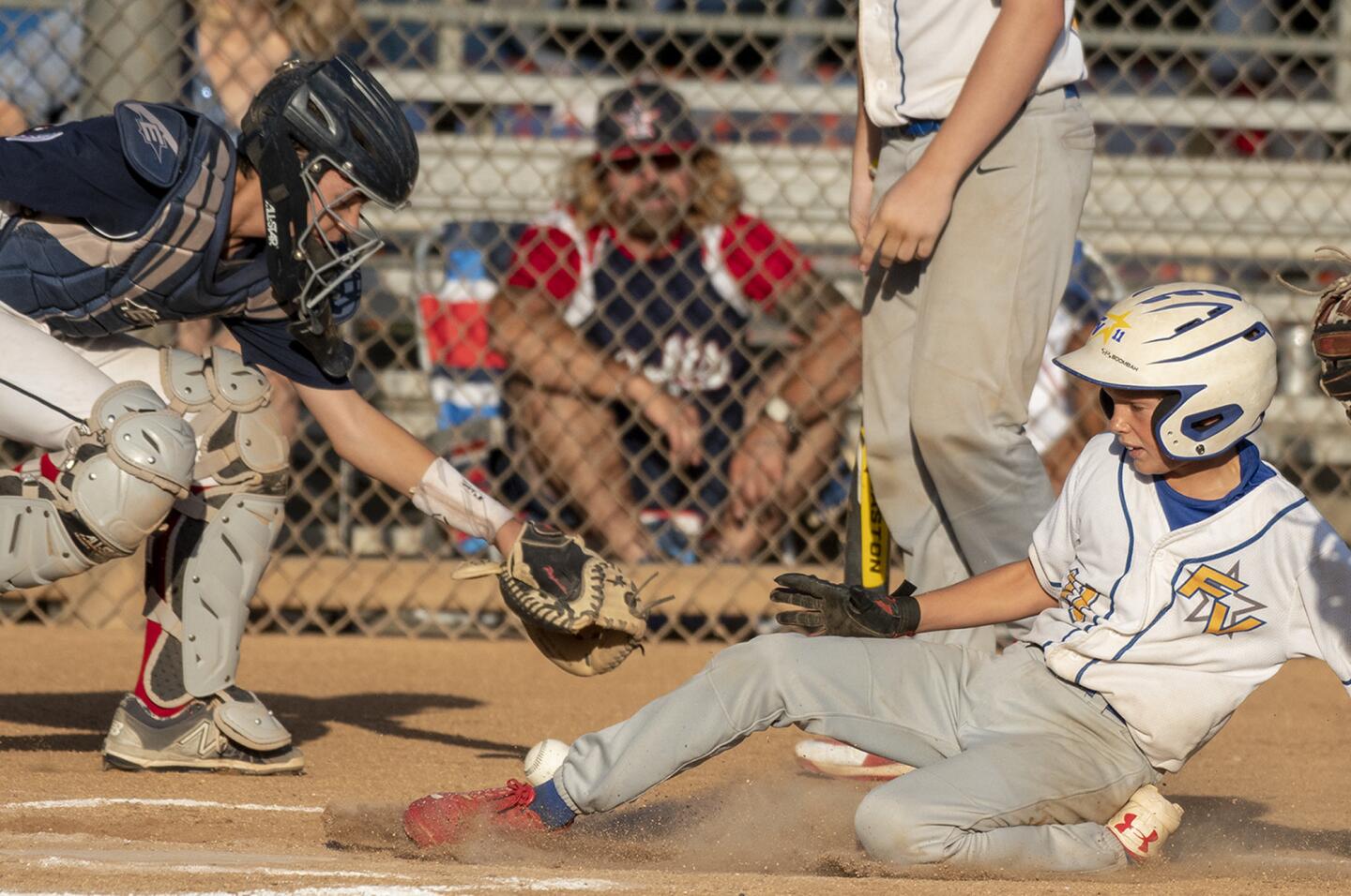 Fountain Valley's Quinn Hartman scores in the fith inning against Irvine during a PONY Bronco 12-and-under Regional tournament at Hicks Canyon Park in Irvine on Thursday, July 12.
