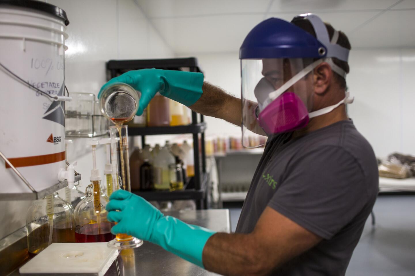 Robert Steed, owner of Alchemy e-Lixers, pours favor juice into a beaker. The vaping community fears that FDA regulations will inadvertently favor the big tobacco companies' disposable cigarettes, essentially bringing the independent e-cig industry to an abrupt halt.