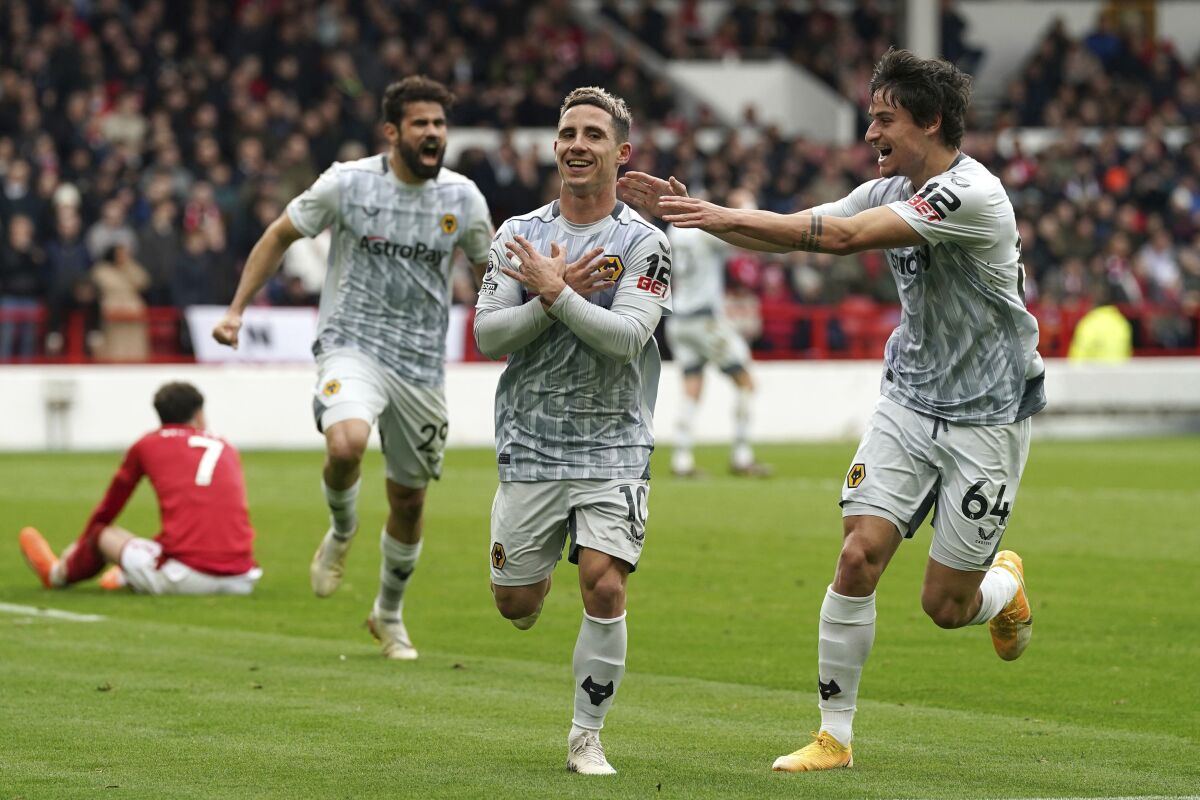 Wolverhampton Wanderers' Daniel Podence, center, celebrates scoring their side's first goal of the game during their English Premier League soccer match against Nottingham Forest at the City Ground, Nottingham, England, Saturday, April 1, 2023. (Nick Potts/PA via AP)