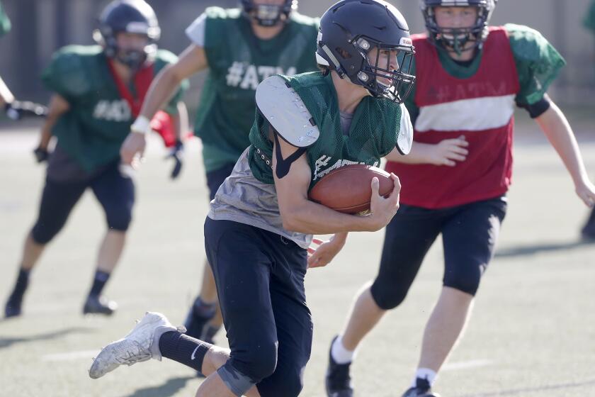 Sage Hill School quarterback Van Freund carries the ball during practice on Wednesday in Newport Beach.