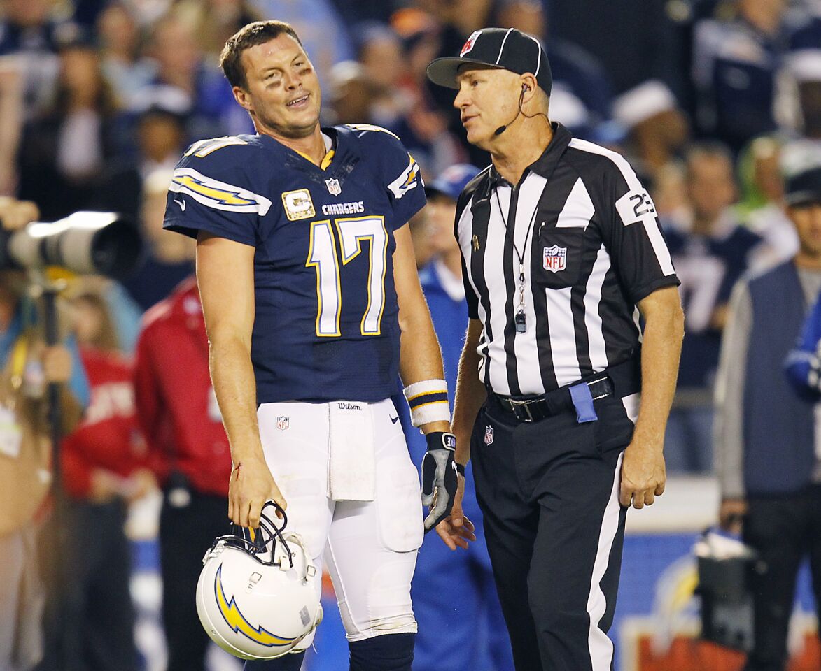 Chargers Philip Rivers stands in disbelief after D.J. Fluker was called for illegally being downfield forcing an Antonio Gates touchdown to be called back in the 4th quarter. Linesman Marc Hittner looks on during the Monday Night Football game on Nov. 9. 2015