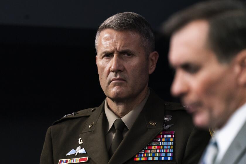 U.S. Army Maj. Gen. William Taylor, Joint Staff Operations, listens to Pentagon spokesman John Kirby at a news briefing.