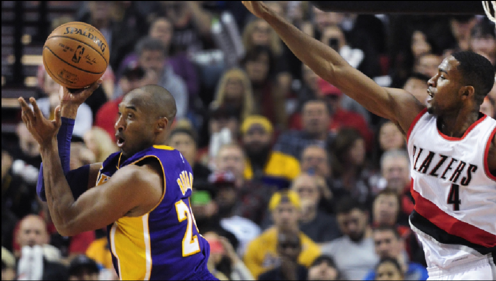 Kobe Bryant looks to make a play as Portland's forward Maurice Harkless defends.