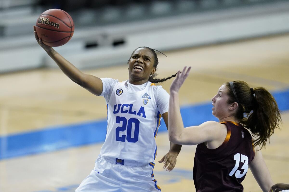 UCLA guard Charisma Osborne shoots over Arizona State guard Maggie Besselink.