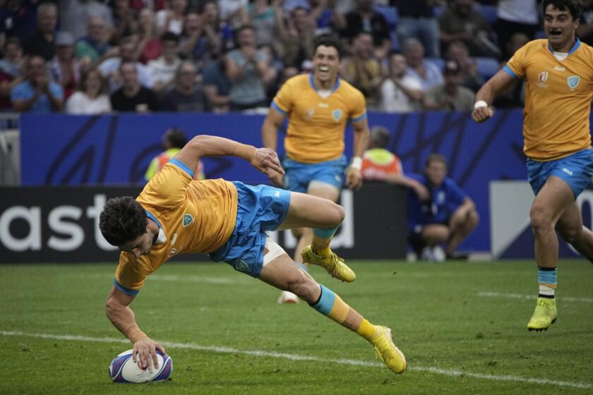 Uruguay's Santiago Arata scores a try during the Rugby World Cup Pool A match between Uruguay and Namibia at the OL Stadium in Lyon, France, Wednesday, Sept. 27, 2023. (AP Photo/Laurent Cipriani)