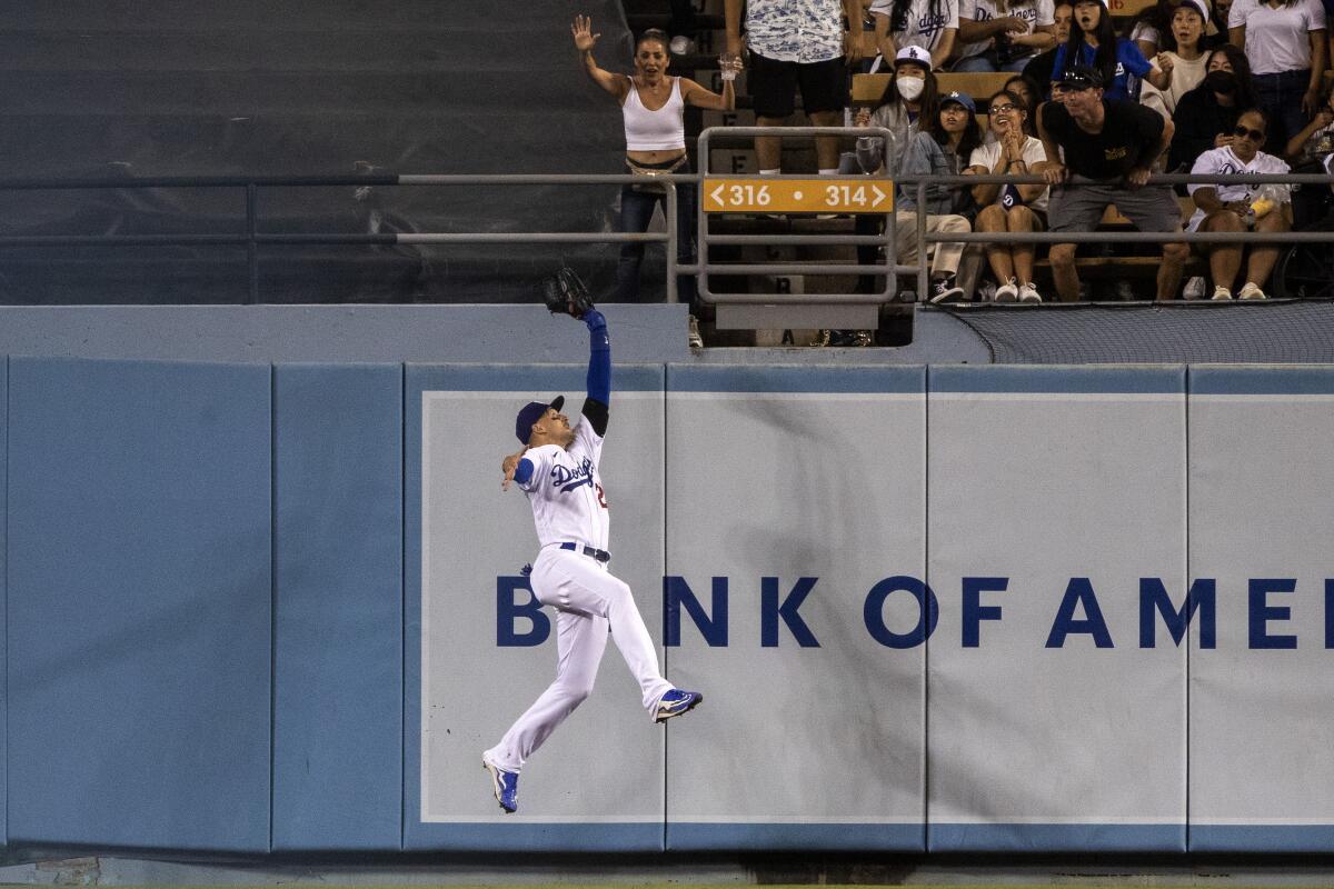 Center fielder Trayce Thompson makes a leaping catch at the wall in the ninth inning for the Dodgers on Aug. 19, 2022.
