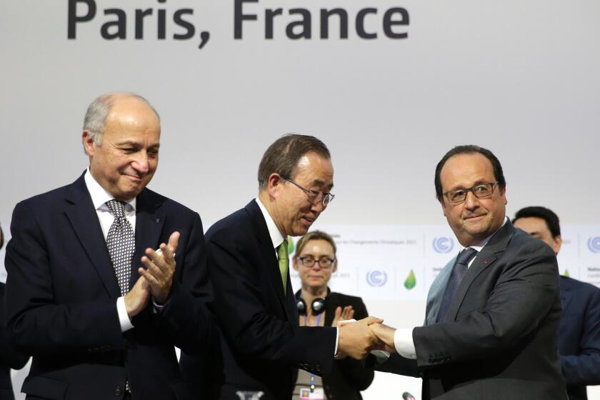 French Foreign Minister Laurent Fabius, left, U.N. Secretary-General Ban Ki-moon, center, and French President Francois Hollande at the final session of the climate change conference Paris, which finally secured a long-sought international agreement.