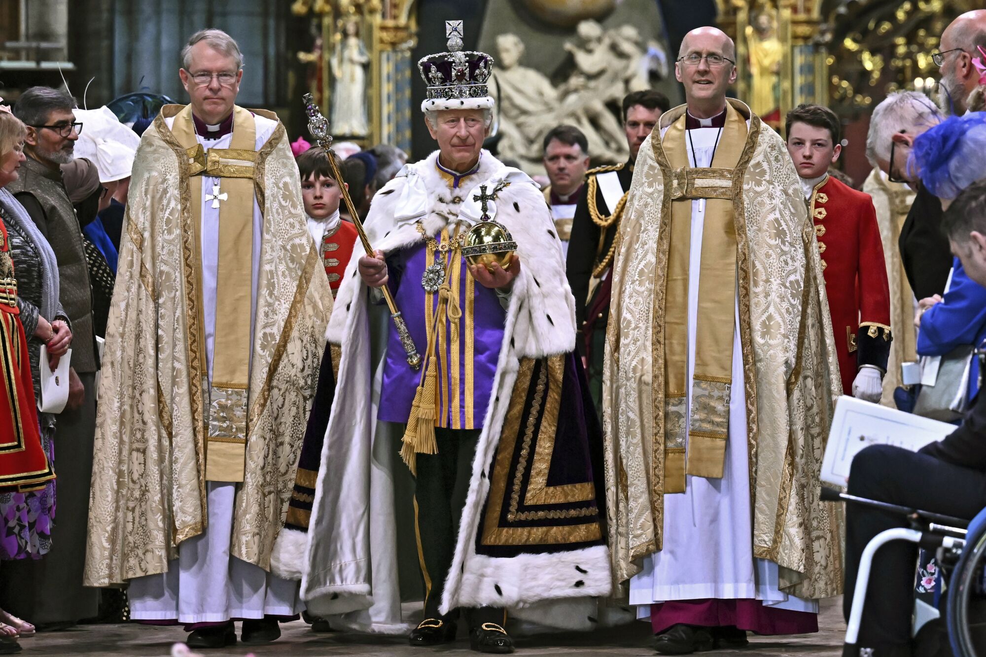 Flanked by priests, Britain's King Charles III leaves Westminster Abbey
