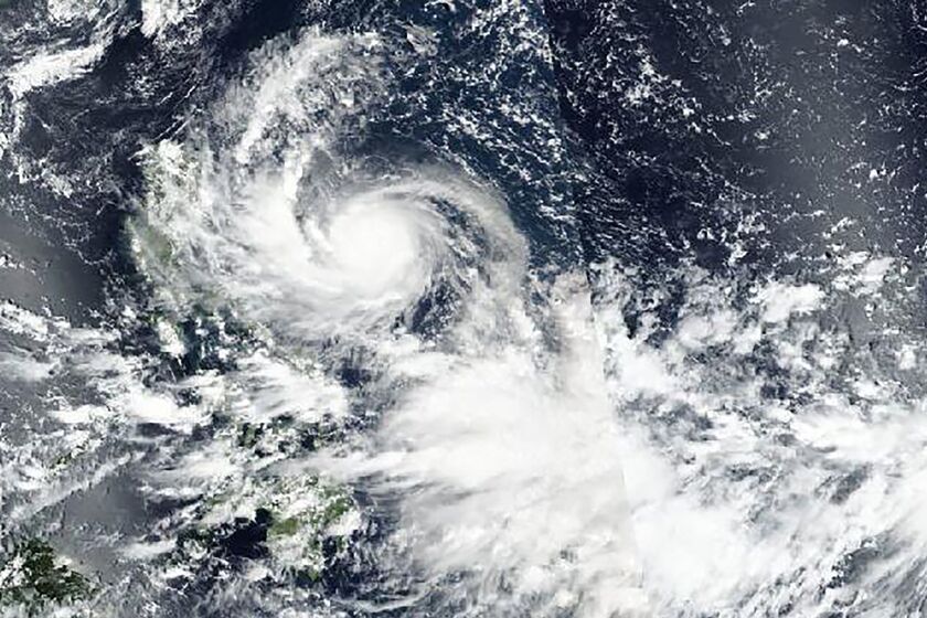 This Saturday, Sept. 24, 2022 satellite image released by NASA shows Typhoon Noru approaching Philippines. (NASA Worldview, Earth Observing System Data and Information System (EOSDIS) via AP)