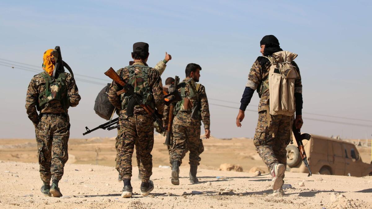 Members of the U.S.-backed Syrian Democratic Forces patrol in the village of Tal Aaj, about 30 miles north of Raqqah, on Nov. 7, 2016.