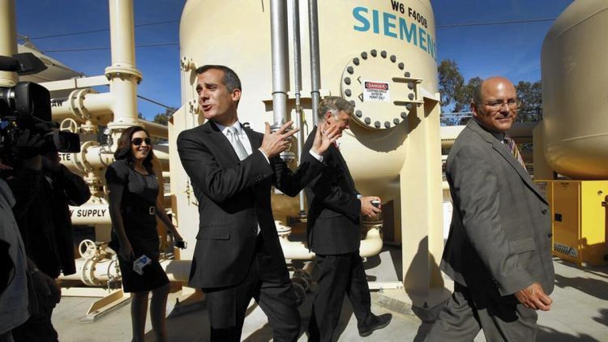 Los Angeles Mayor Eric Garcetti walks with Department of Water and Power officials at an Arleta facility.