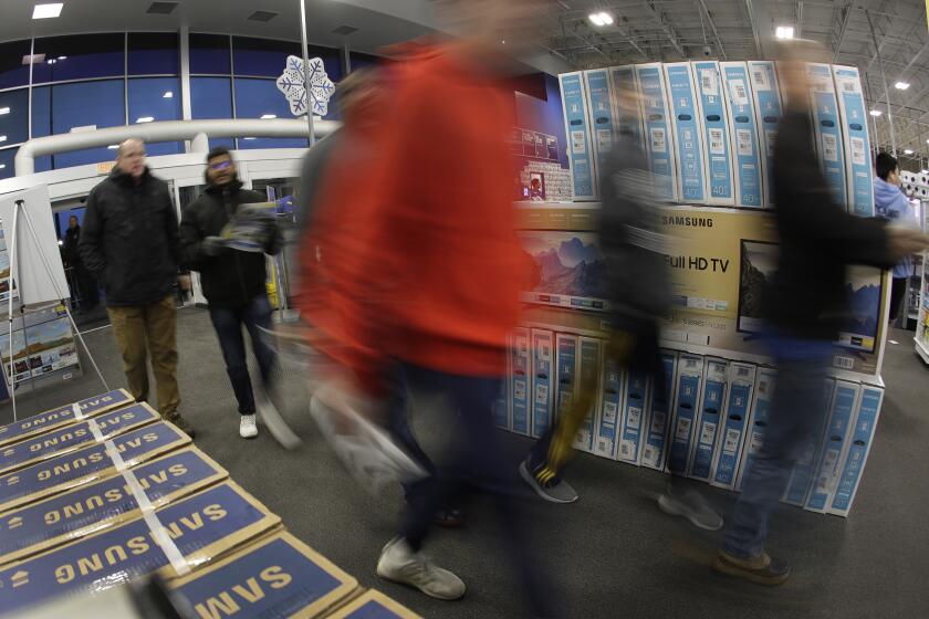 Shoppers enter a Best Buy store for a Black Friday sale Thursday, Nov. 28, 2019, in Overland Park, Kan. (AP Photo/Charlie Riedel)
