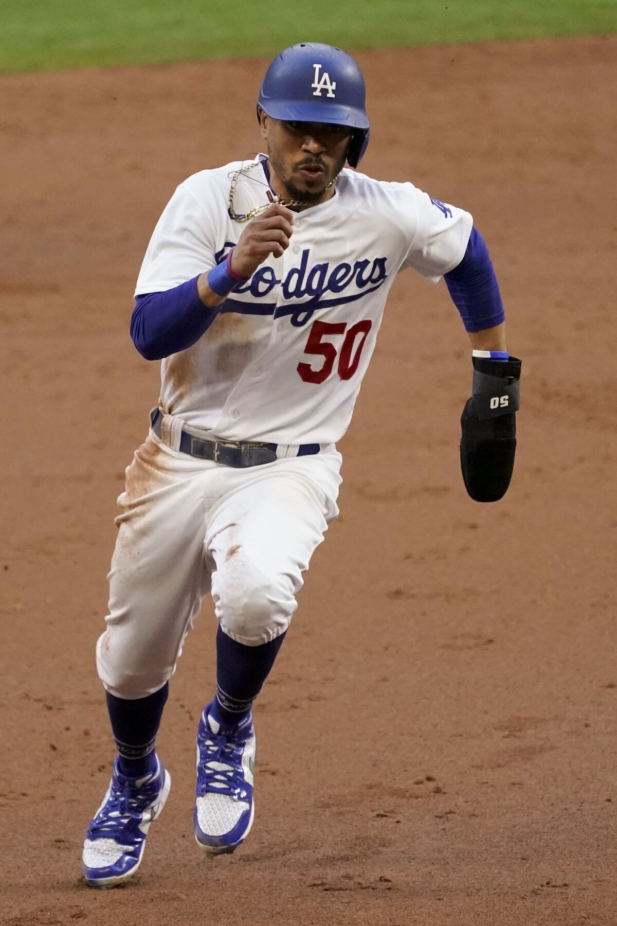 Dodgers baserunner Mookie Betts runs to third during the fourth inning against the Braves on Tuesday.