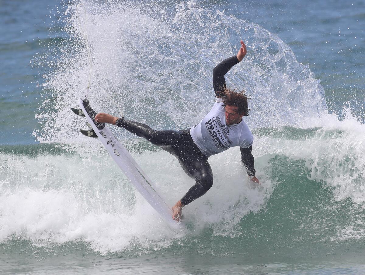 Ryan Huckabee completes a nose-pick air reverse at the U.S. Open of Surfing on Wednesday.