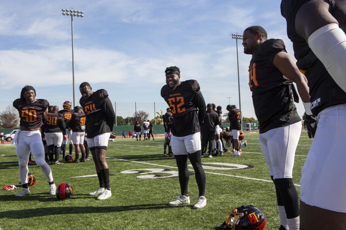 Tre' Williams, center, cools down with his new teammates.