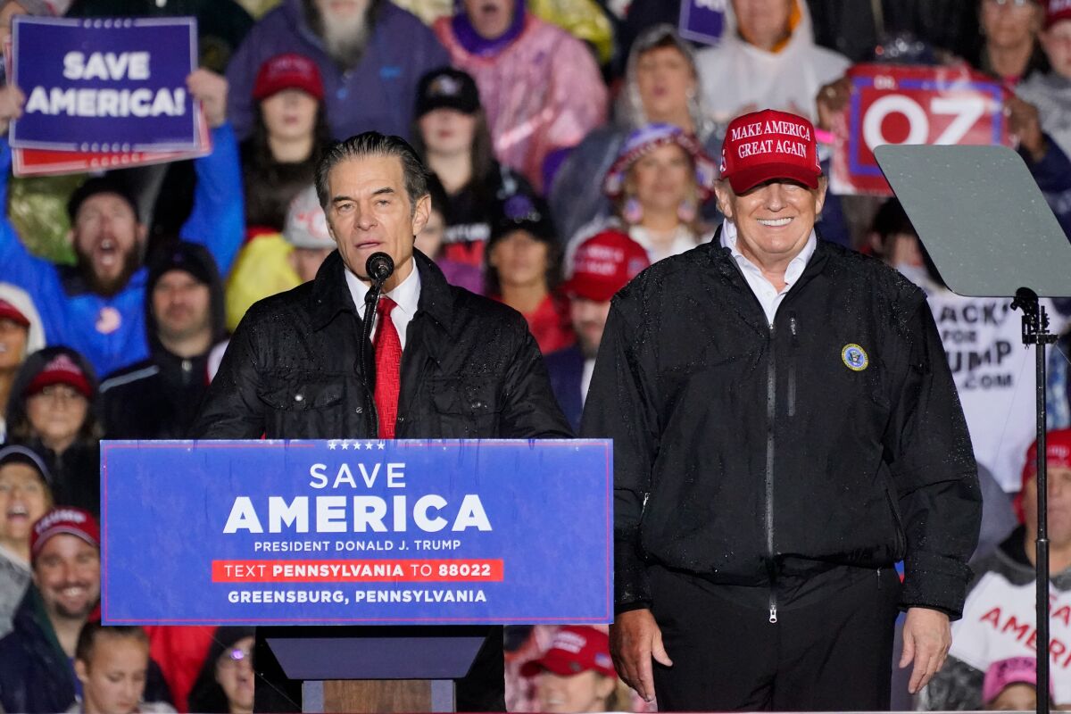 Pennsylvania Senate candidate Mehmet Oz, left, accompanied by former President Donald Trump speaks at a campaign rally in Greensburg, Pa., Friday, May 6, 2022. (AP Photo/Gene J. Puskar)